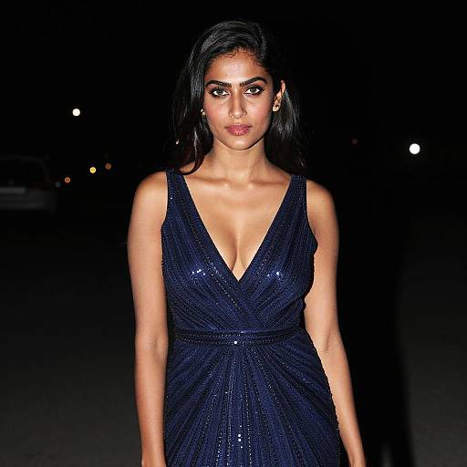Elegant Woman in Navy Blue Sequin Evening Gown at Night