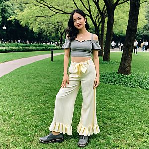 Young Woman in Stylish Casual Outfit Standing in Green Park