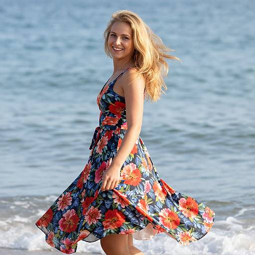 Young Woman in Floral Dress Spinning at the Beach by the Ocean