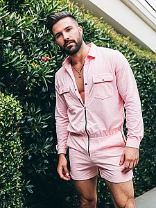Man Wearing Pink Romper Shirt and Shorts Standing by Greenery