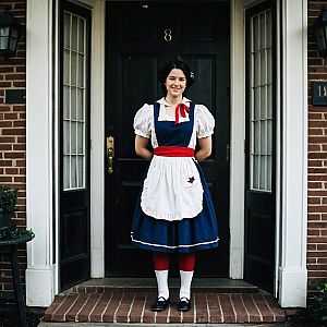 Young Woman in Vintage Blue Dress with Apron