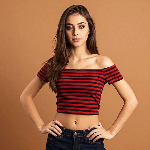 Woman Wearing Red Black Striped Crop Top with Jeans Posing Confidently