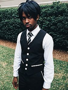 Black Male Anime Cosplay Wearing Black Vest and White Shirt Outdoors