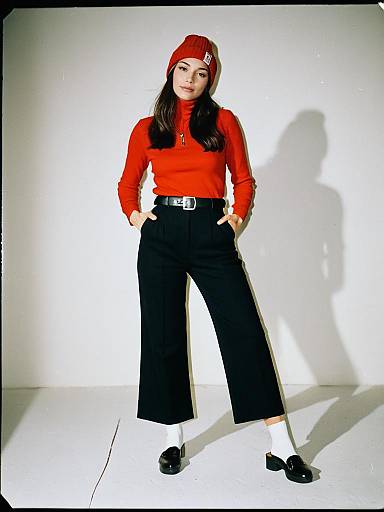 Casual Chic Woman in Red Fitted Turtleneck and Black Wide-Leg Trousers