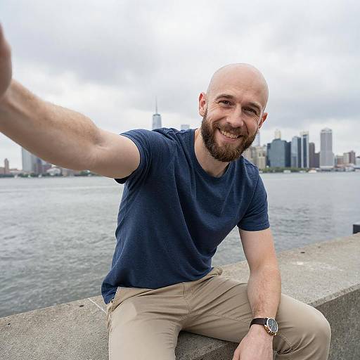 Smiling Bald Man Taking Selfie by City Waterfront