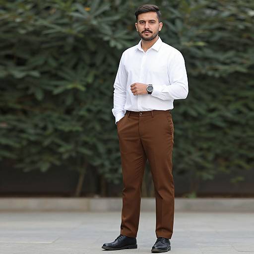 Confident Man in White Shirt and Brown Trousers Outdoors