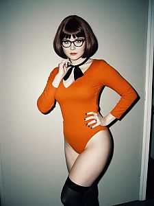 Woman in Velma Halloween Costume Photorealistic Glamour Cosplay Photo