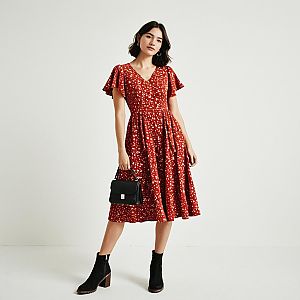 Woman in Vintage Red Midi Dress with Floral Print