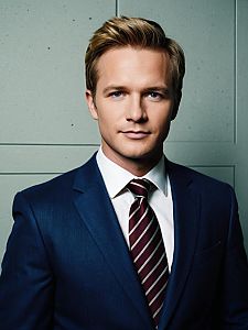 Man in Barney Stinson Cosplay Costume Wearing Blue Suit and Striped Tie Realistic Photo