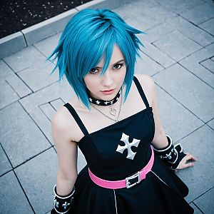 Blue-Haired Woman in Anime-Inspired Black Dress with Pink Belt Urban Cosplay