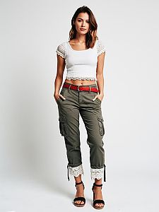 Stylish Woman in White Cropped Top and Olive Cargo Pants with Lace Detailing