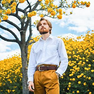Confident Man in Yellow Flowers