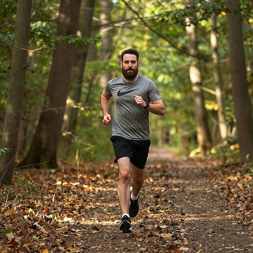Bearded Man Running on Forest Trail in Athletic Wear
