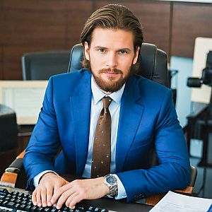 Confident man in blue suit at office desk