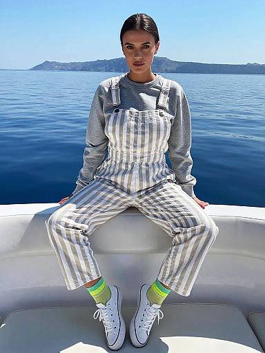 Petite Woman in Casual Beige and White Striped Overalls on Boat