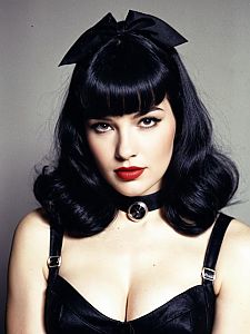 Woman in Bettie Page Bangs Hairstyle and Leather Costume Professional Cosplay