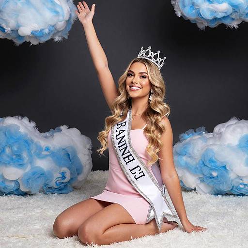 Smiling Woman in Pink Dress Wearing Crown and Baninel D'1 Sash with Cloud Decor