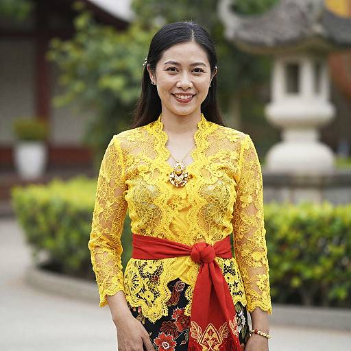 Traditional Balinese Woman in Yellow Lace Kebaya with Red Sash