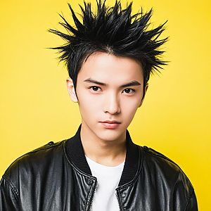 Young Man in Black Leather Jacket Against Yellow Background