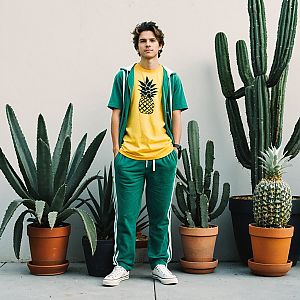 Confident Young Man in Casual Athletic Wear with Cacti