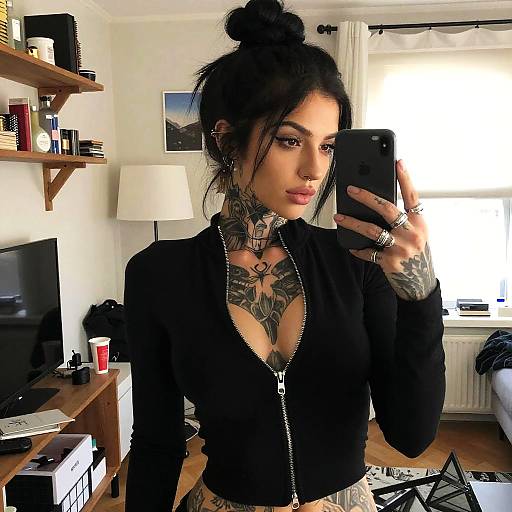 Tattooed Woman Taking Mirror Selfie in Black Zip-up Top