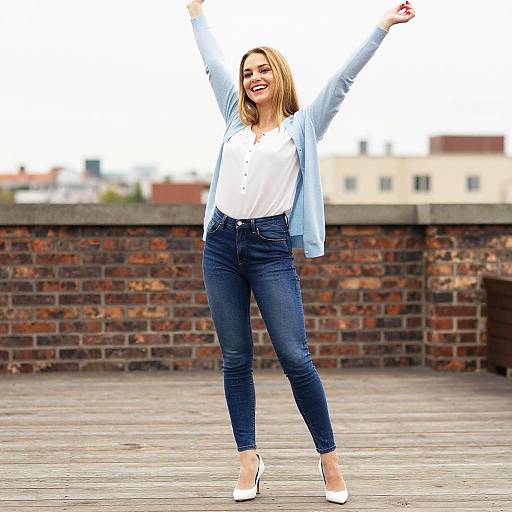 Happy Woman Celebrating Outdoors in Casual Blue and White Outfit
