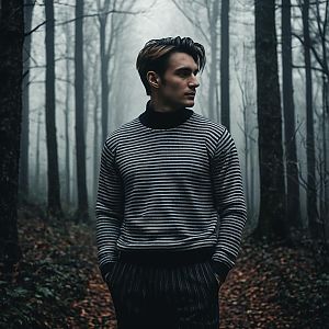 Contemplative Young Man in Misty Forest