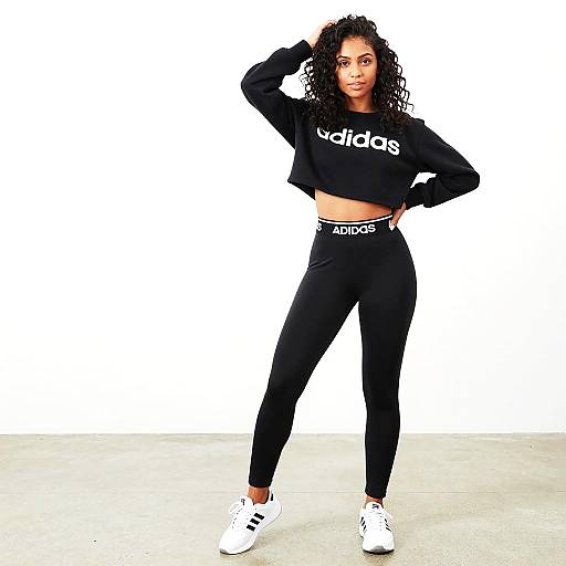 Woman in Black Adidas Tracksuit and White Sneakers Standing in Studio