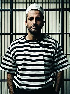 Man in Classic Prison Costume Waist-Up Editorial Photo