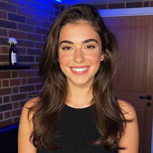 Portrait of Smiling Gen Z Woman with Natural Makeup and Long Hair Indoors
