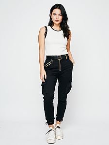 Stylish Woman in White Sleeveless Top and Black Cargo Pants Standing Confidently