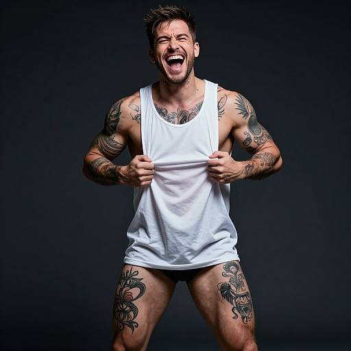 Muscular Tattooed Man Laughing Boldly in White Tank Top