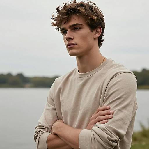 Pensive Young Man in Casual Beige Sweatshirt by the Lake