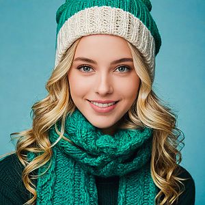 Smiling Young Woman in Teal Scarf and Beanie