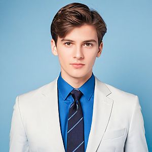 Young Man in Light Suit with Blue Shirt and Tie