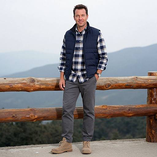 Man in Plaid Shirt and Puffer Vest on Mountain Overlook