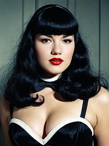 Woman in Bettie Page Bangs Hairstyle and Vintage Pin-Up Costume Cosplay