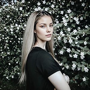 Young Woman in White Flower Backdrop