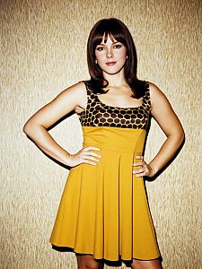 Confident Woman in Retro Mustard Yellow Dress with Honeycomb Pattern