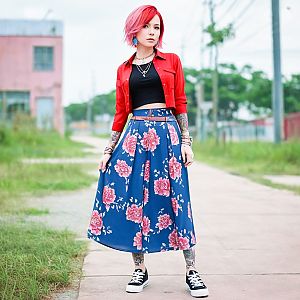 Stylish young woman with red hair in street fashion