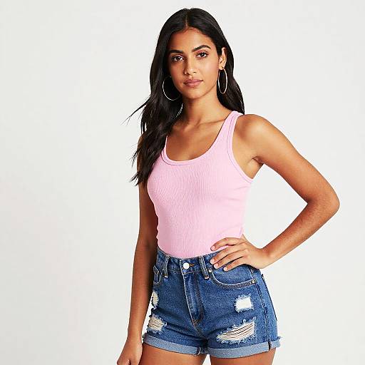 Young Woman in Pink Tank Top and Distressed Denim Shorts