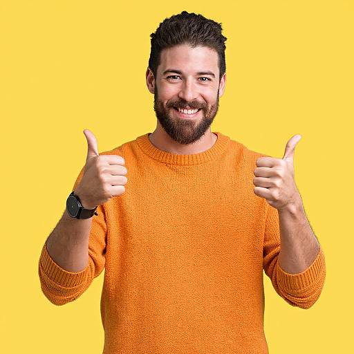 Smiling Man in Orange Sweater Giving Thumbs Up on Yellow Background