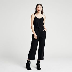 Woman Wearing Modern Minimalist Black Sleeveless Jumpsuit with Thin Straps