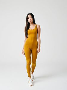 Woman in Mustard Yellow Athletic Unitard with Scoop Neckline