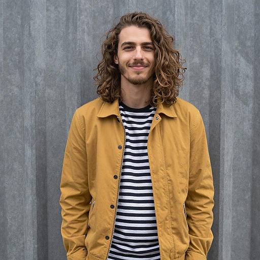 Smiling Young Man in Mustard Jacket and Striped Shirt