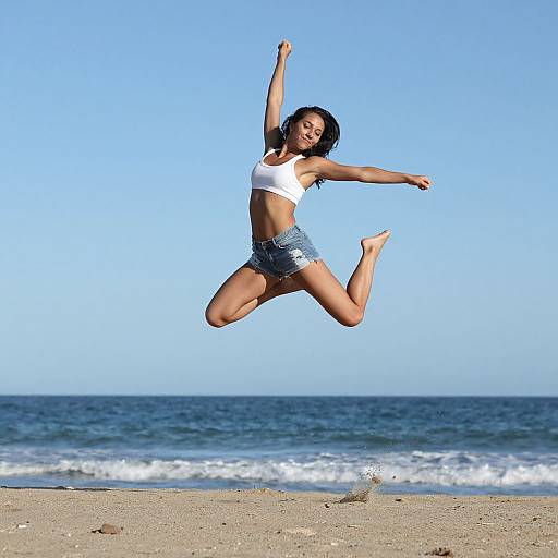 Young Woman Jumping on Beach with Ocean Background