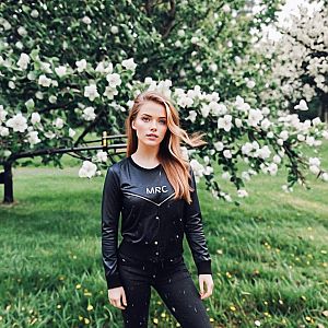 Confident Woman in Stylish Black Outfit in Green Park