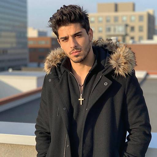 Young Man Wearing Stylish Black Coat with Fur Hood in Urban Setting