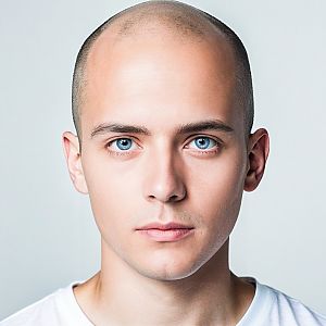Close-up portrait of a young man with blue eyes