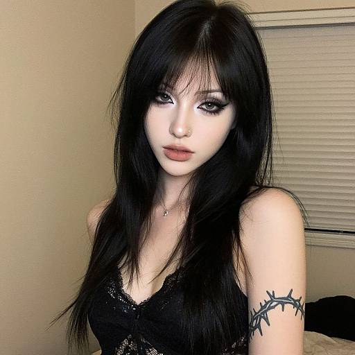 Portrait of Woman with Black Hair and Barbed Wire Tattoo in Black Lace Top